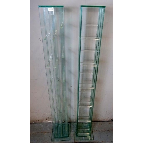 836 - A pair of contemporary glass shelving units by Greenapple furniture company, each housing six shelve... 