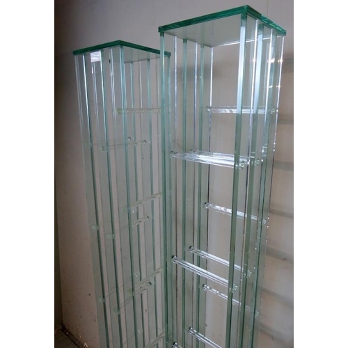 836 - A pair of contemporary glass shelving units by Greenapple furniture company, each housing six shelve... 