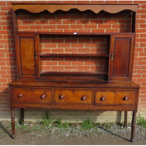 837 - A Georgian oak high back dresser with plate-rack shelving flanked by inlaid cupboards, over a sidebo... 