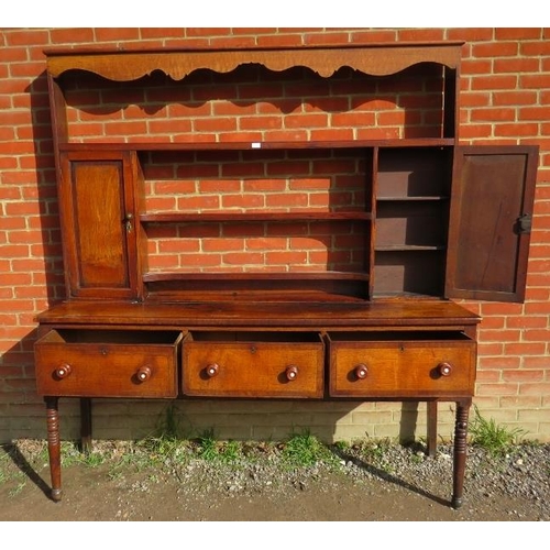 837 - A Georgian oak high back dresser with plate-rack shelving flanked by inlaid cupboards, over a sidebo... 