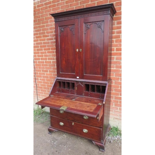 838 - A 18th century mahogany bureau bookcase featuring dentil cornice and blind fret frieze, the twin doo... 