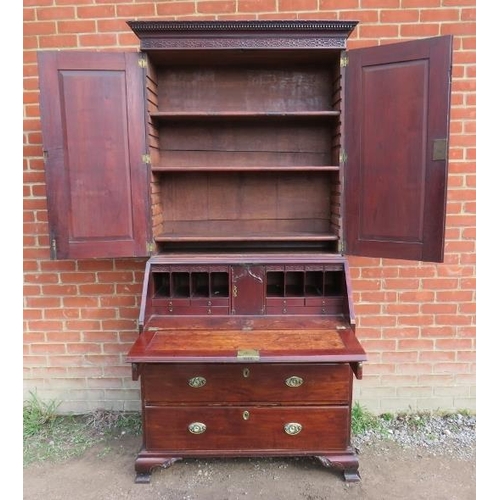 838 - A 18th century mahogany bureau bookcase featuring dentil cornice and blind fret frieze, the twin doo... 