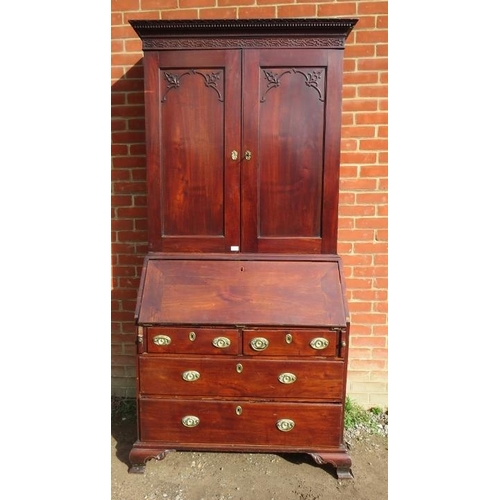 838 - A 18th century mahogany bureau bookcase featuring dentil cornice and blind fret frieze, the twin doo... 