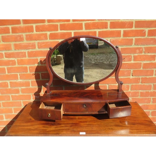 840 - A Georgian mahogany oval swing vanity mirror, the bow fronted box base housing three drawers, on bun... 