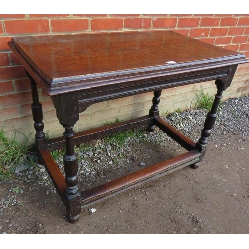 843 - A 19th century oak side table in a 17th century taste, on baluster turned supports united by stretch... 