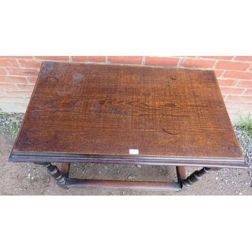 843 - A 19th century oak side table in a 17th century taste, on baluster turned supports united by stretch... 