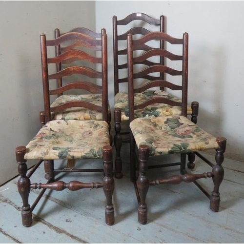 850 - Four 19th century ladder back chairs raised on baluster turned supports with stretchers, terminating... 