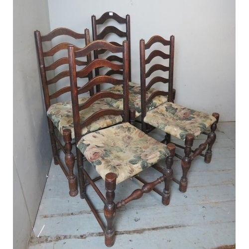 850 - Four 19th century ladder back chairs raised on baluster turned supports with stretchers, terminating... 