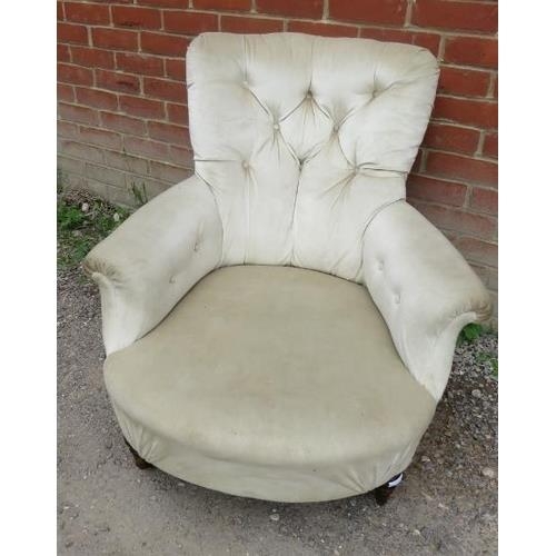 851 - A Victorian low bedroom armchair upholstered in a cream buttoned velvet, raised on tapering turned s... 