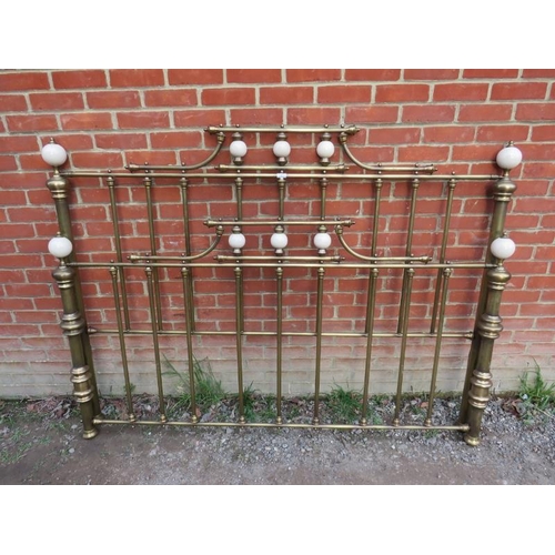 853 - A vintage brass double bedstead featuring ceramic ball finials.
Condition report: No side rails.
H14... 