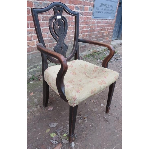 855 - A Georgian country made oak shield back open sided elbow chair, the carved and pierced back splat de... 