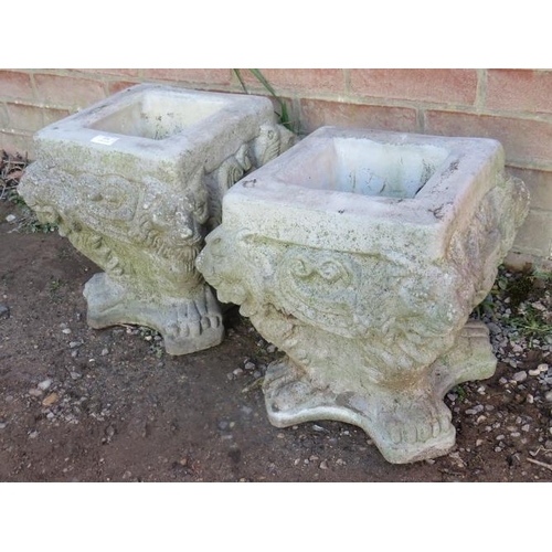 856 - A pair of nicely weathered reconstituted stone planters with lion mask corners, on lions paw feet.
C... 