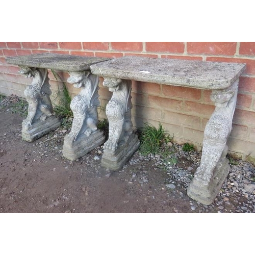 859 - A pair of nicely weathered reconstituted stone garden tables, on supports in the form of dragons.
Co... 