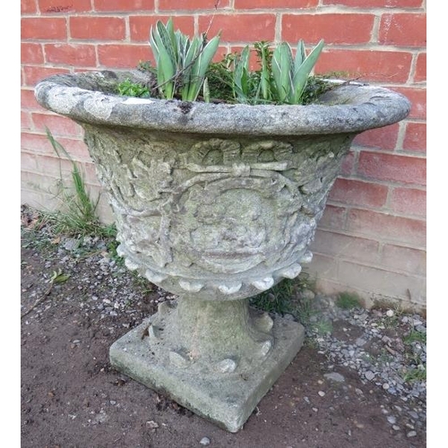 865 - A nicely weathered reconstituted stone garden urn with fruiting vine relief decoration.
Condition re... 