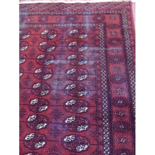 904 - An early to mid Persian Baluch rug on red ground. 188cm x 140cm.
Condition report: Some wear to main... 