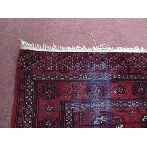 904 - An early to mid Persian Baluch rug on red ground. 188cm x 140cm.
Condition report: Some wear to main... 