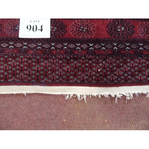 904 - An early to mid Persian Baluch rug on red ground. 188cm x 140cm.
Condition report: Some wear to main... 