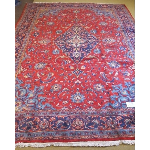 905 - A superb Sarough carpet with central blue diamond motif on a red ground in excellent condition. 340c... 