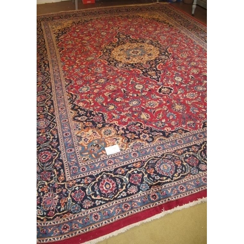 907 - A superb quality meshed carpet central motif on claret ground with blue border. 3.75 x 3.00
Conditio... 