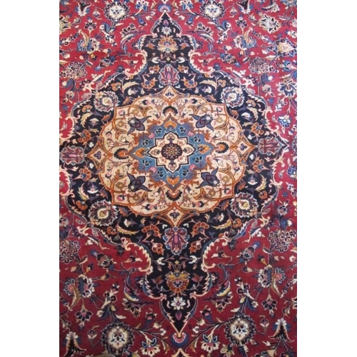 907 - A superb quality meshed carpet central motif on claret ground with blue border. 3.75 x 3.00
Conditio... 