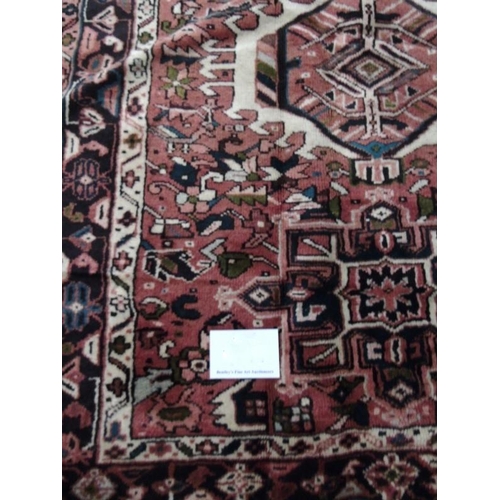 914 - A good Karajeh Persian runner, with repeat central medallions on a blush field, in very clean condit... 