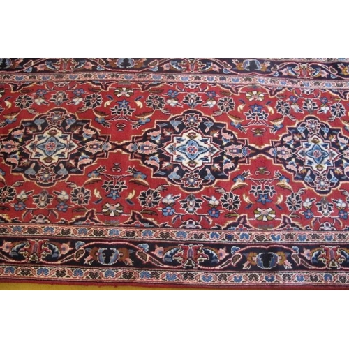 916 - A good Kashan runner 4 central repeat pattern on burnt amber ground. 2.90 x 90
Condition report: Goo... 