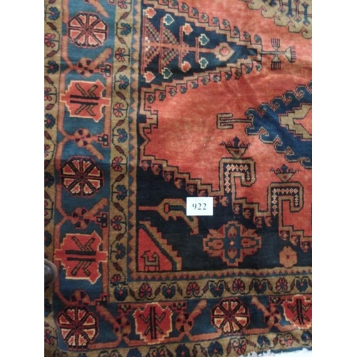 922 - A Persian Vles carpet, blue and taype motifs on a burnt orange/red ground. 380cm x 255cm.
Condition ... 