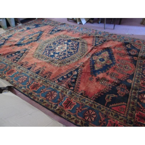 922 - A Persian Vles carpet, blue and taype motifs on a burnt orange/red ground. 380cm x 255cm.
Condition ... 