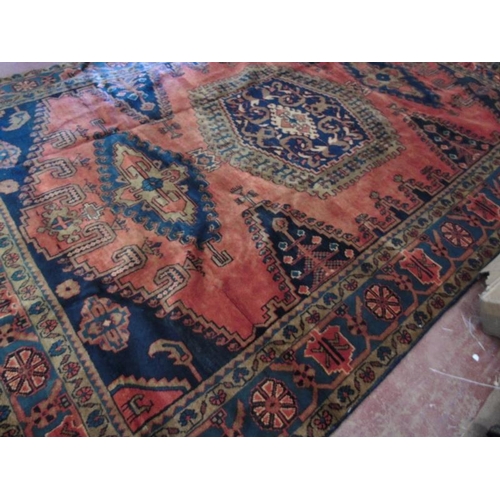 922 - A Persian Vles carpet, blue and taype motifs on a burnt orange/red ground. 380cm x 255cm.
Condition ... 