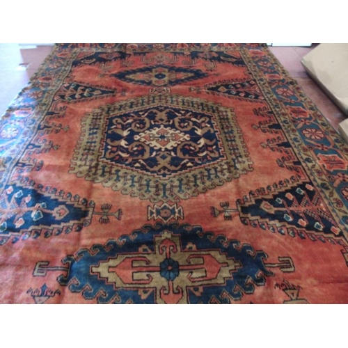 922 - A Persian Vles carpet, blue and taype motifs on a burnt orange/red ground. 380cm x 255cm.
Condition ... 