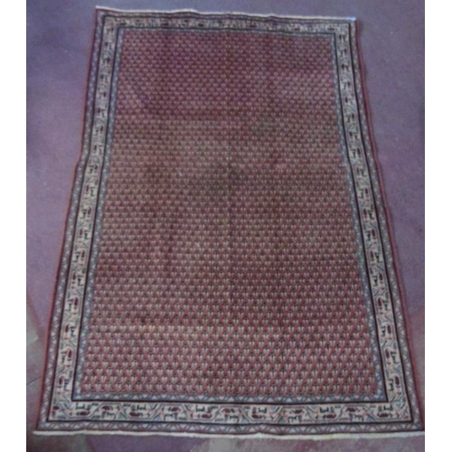 931 - A good quality Araak rug with close repeat pattern on burnt amber ground. 2.03x1.40