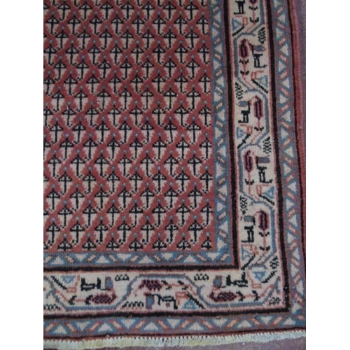 931 - A good quality Araak rug with close repeat pattern on burnt amber ground. 2.03x1.40