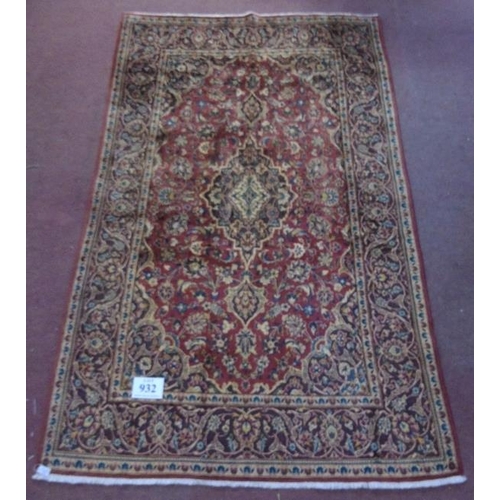 932 - A fine Kashan (Persian) rug on a claret ground, the central motif & borders on a brown ground. 2.18x... 