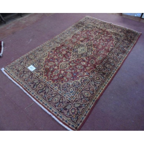 932 - A fine Kashan (Persian) rug on a claret ground, the central motif & borders on a brown ground. 2.18x... 