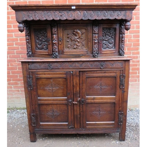 871 - A large antique 17th century style oak court cupboard of three cupboards over one long drawer and ba... 