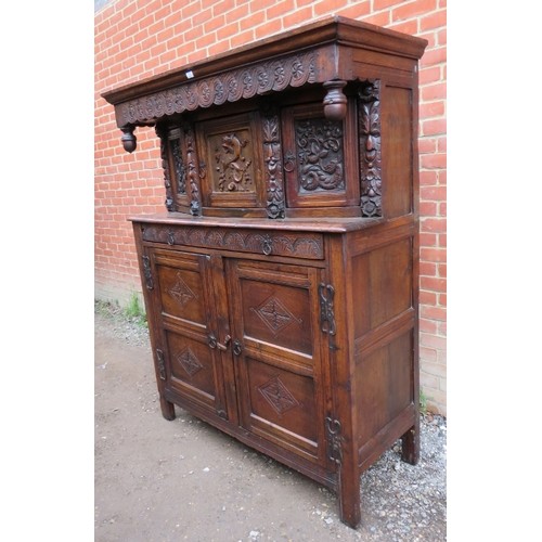 871 - A large antique 17th century style oak court cupboard of three cupboards over one long drawer and ba... 