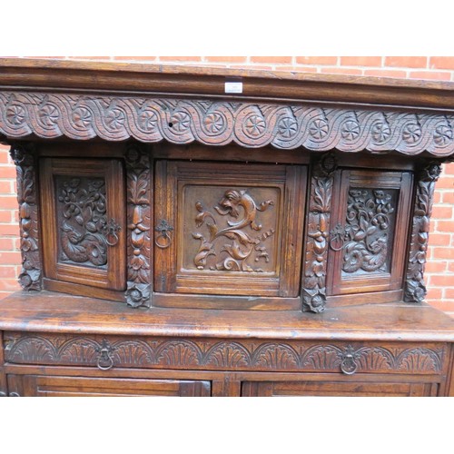 871 - A large antique 17th century style oak court cupboard of three cupboards over one long drawer and ba... 