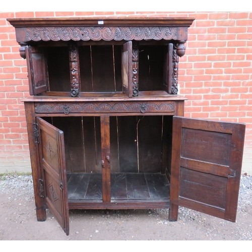 871 - A large antique 17th century style oak court cupboard of three cupboards over one long drawer and ba... 