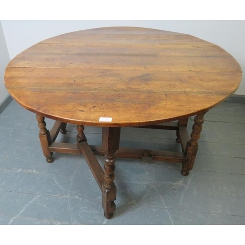 702 - An 18th century fruitwood oval gateleg table of excellent colour, on turned supports. 
Condition rep... 