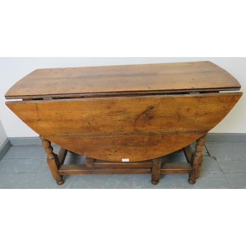 702 - An 18th century fruitwood oval gateleg table of excellent colour, on turned supports. 
Condition rep... 