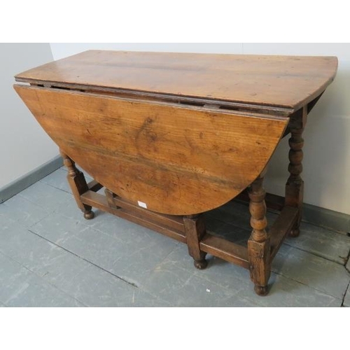 702 - An 18th century fruitwood oval gateleg table of excellent colour, on turned supports. 
Condition rep... 
