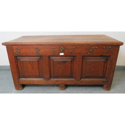 704 - An 18th century medium oak coffer with internal candle box, fielded panels to front and applied bras... 