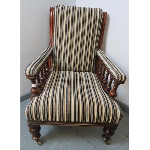 710 - A Victorian mahogany library chair, reupholstered in a contemporary striped chenille material, on ta... 