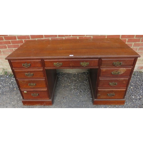 734 - An Edwardian mahogany kneehole desk, housing a configuration of nine graduated drawer, with fancy br... 