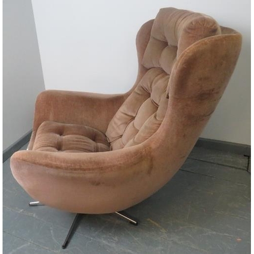 740 - A 1970s wingback ‘Blofeld’ style swivel chair, upholstered in buttoned brown draylon, on a chrome ba... 