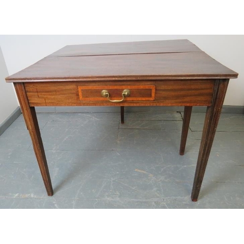 741 - A Georgian mahogany turnover tea table, the inlaid single drawer with brass swan neck handle, on tap... 