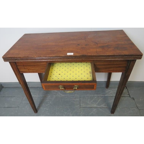 741 - A Georgian mahogany turnover tea table, the inlaid single drawer with brass swan neck handle, on tap... 