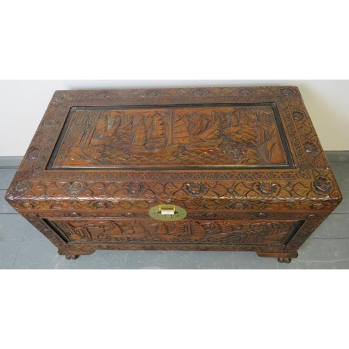 759 - A vintage camphorwood Chinese coffer/blanket box with relief carved panels depicting sailing junks.
... 