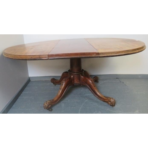 767 - A Victorian walnut circular extending dining table with additional leaf, on a carved and scrolled qu... 