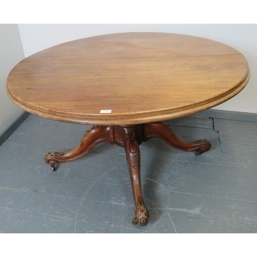 767 - A Victorian walnut circular extending dining table with additional leaf, on a carved and scrolled qu... 